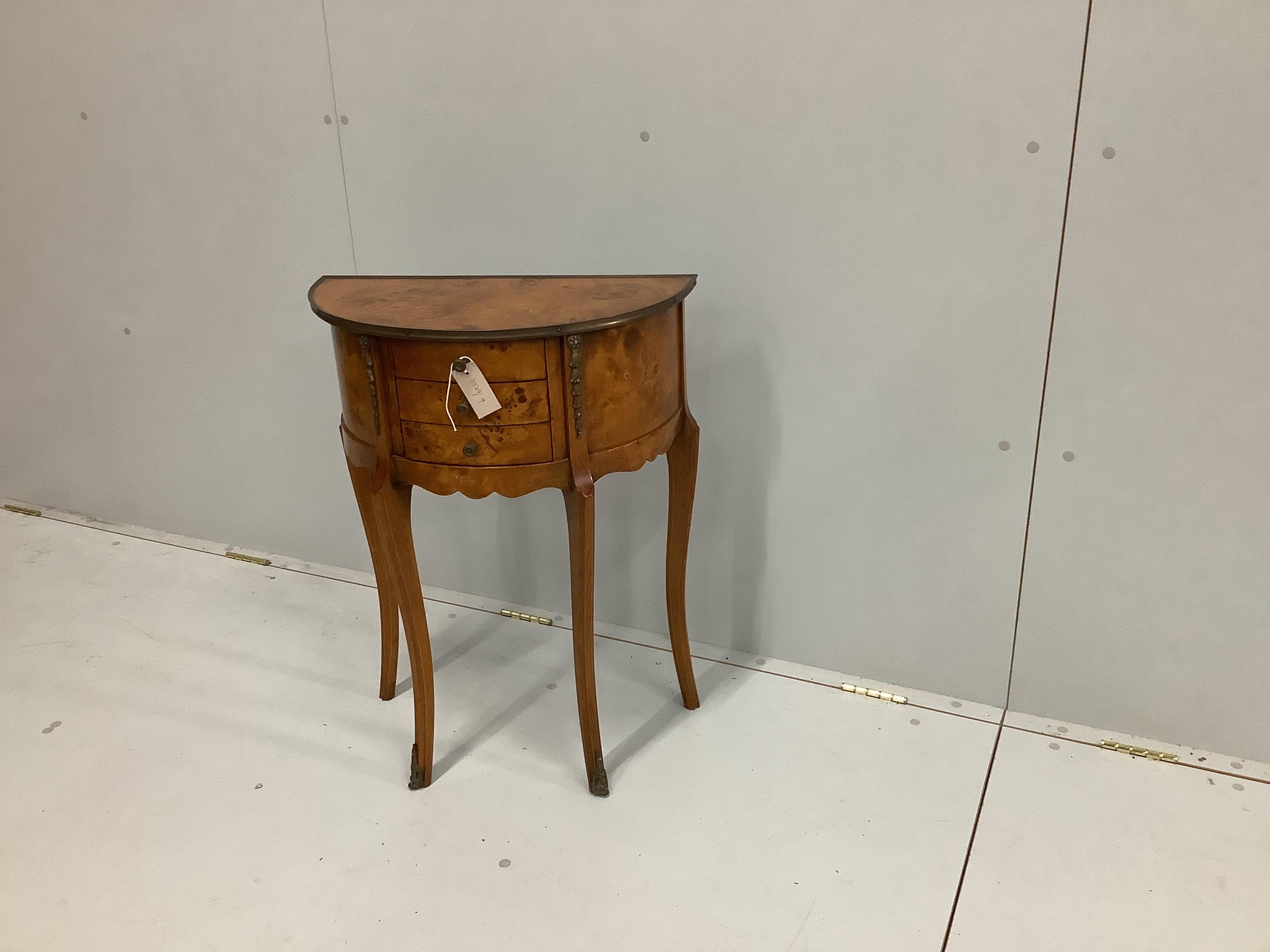 A reproduction bird's eye maple D shaped side table, fitted three drawers, on cabriole legs with gilt metal mounts, width 56cm, depth 29cm, height 73cm